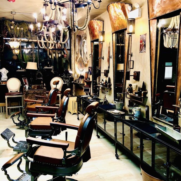 Vintage barber shop interior with antique chairs, wall-mounted mirrors, lighting fixtures, and salon equipment on display